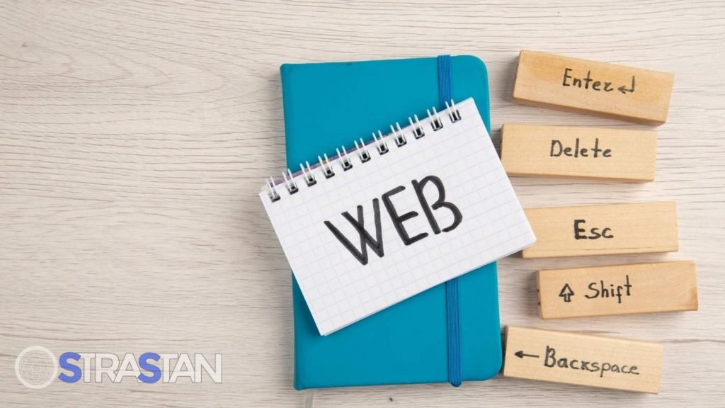 A notepad with the word "WEB" on it, surrounded by wooden blocks with computer key commands, illustrating a visual representation of Tech Comparisons related to web technology.