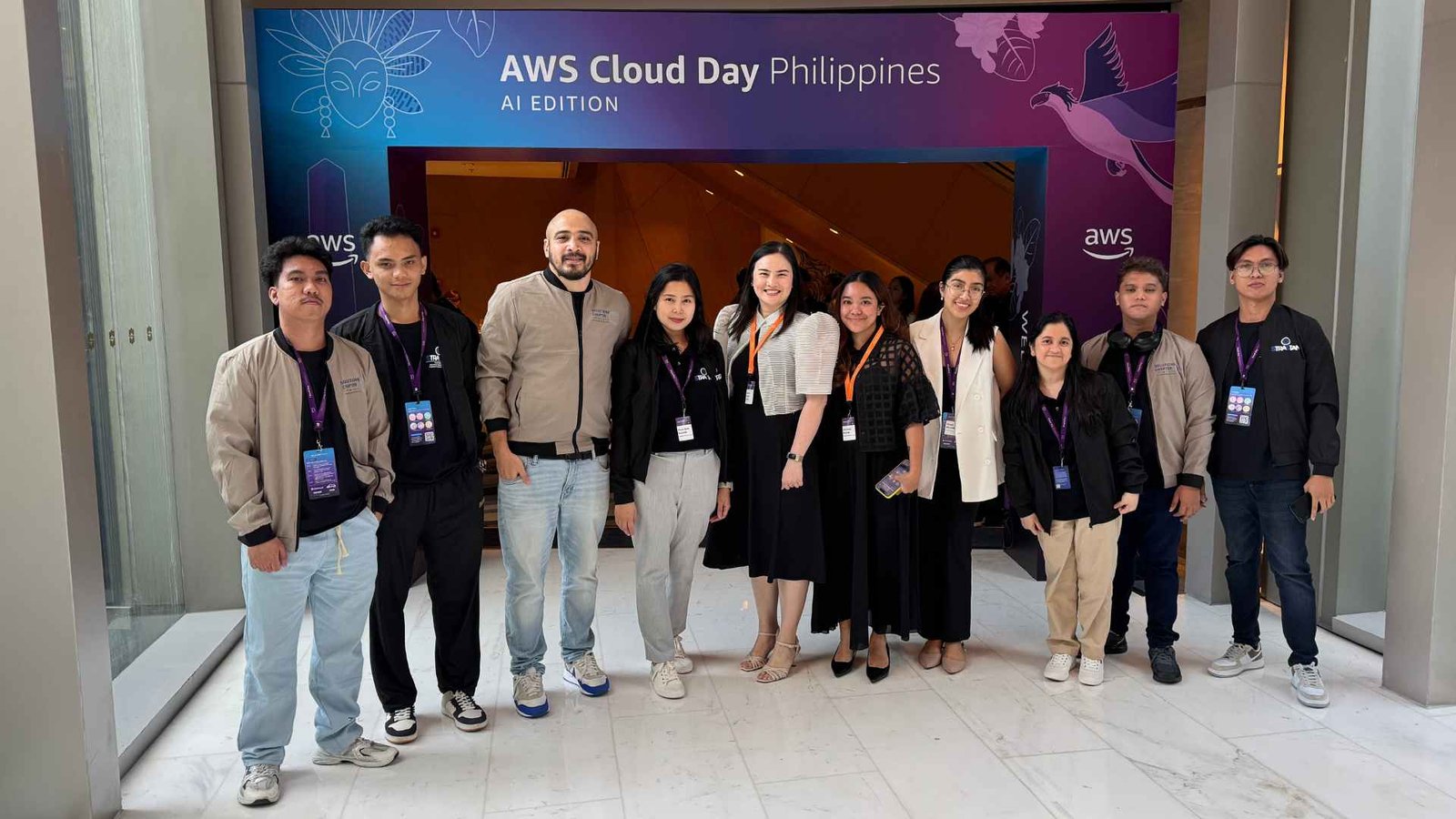 Group photo at AWS Cloud Day Philippines 2025 (AI Edition) featuring StraStan Solutions Corp. and Solutions Chapter Group teams with the AWS team. Includes Account Managers Gwen Chan, Christle Flores; Corporate Executives Ross Sabido (StraStan Solutions Corp.), Mohammad Ali Fereydouni (Solutions Chapter Group Co-Founder & Managing Director); Cloud DevOps, Serverless, Full-Stack & AI Development teams; and AWS Advanced Partners sponsor Julia Villaran (Computerade) supporting skills development programs.