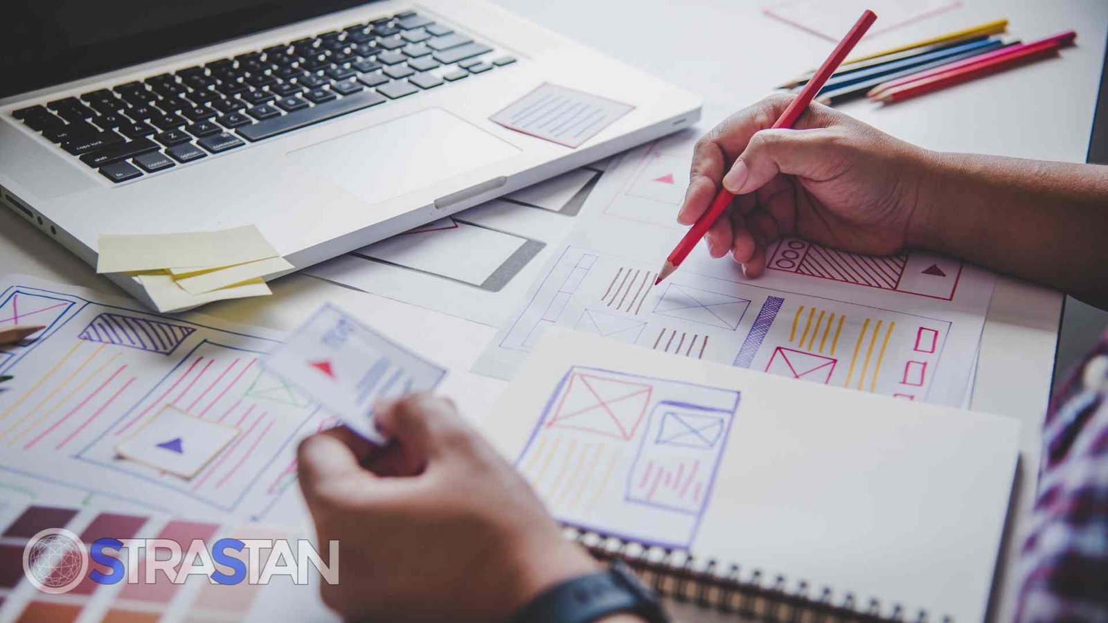A designer sketching a website wireframe, a crucial step in creating user-friendly UX/UI design as part of effective SME solutions.