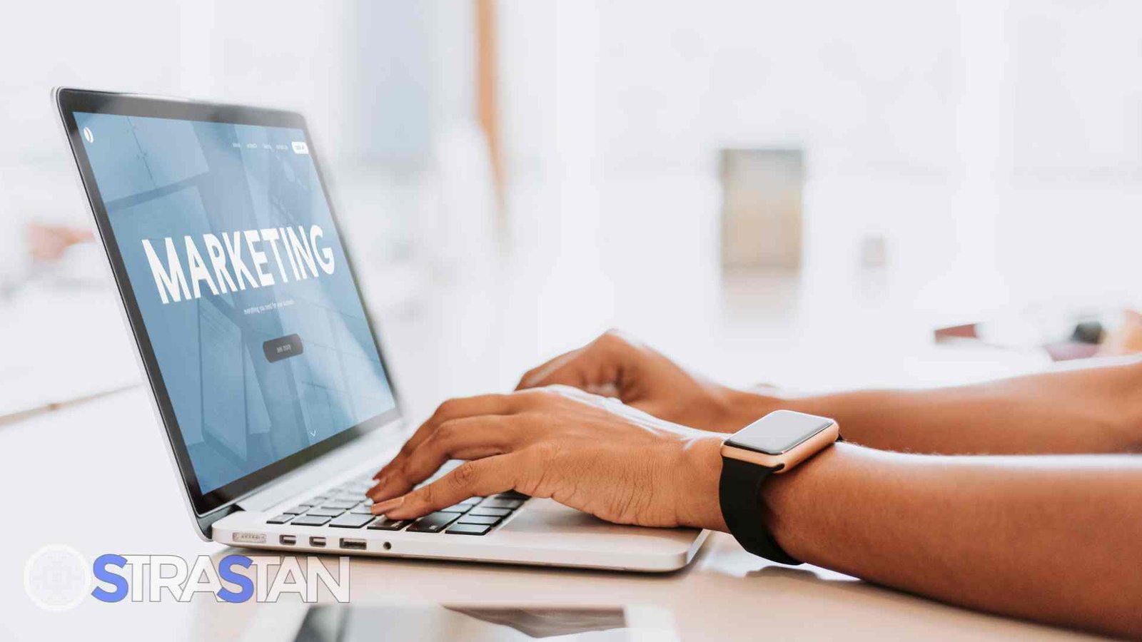 Hands typing on a laptop displaying a marketing strategy webpage, illustrating digital marketing SME solutions for small businesses.