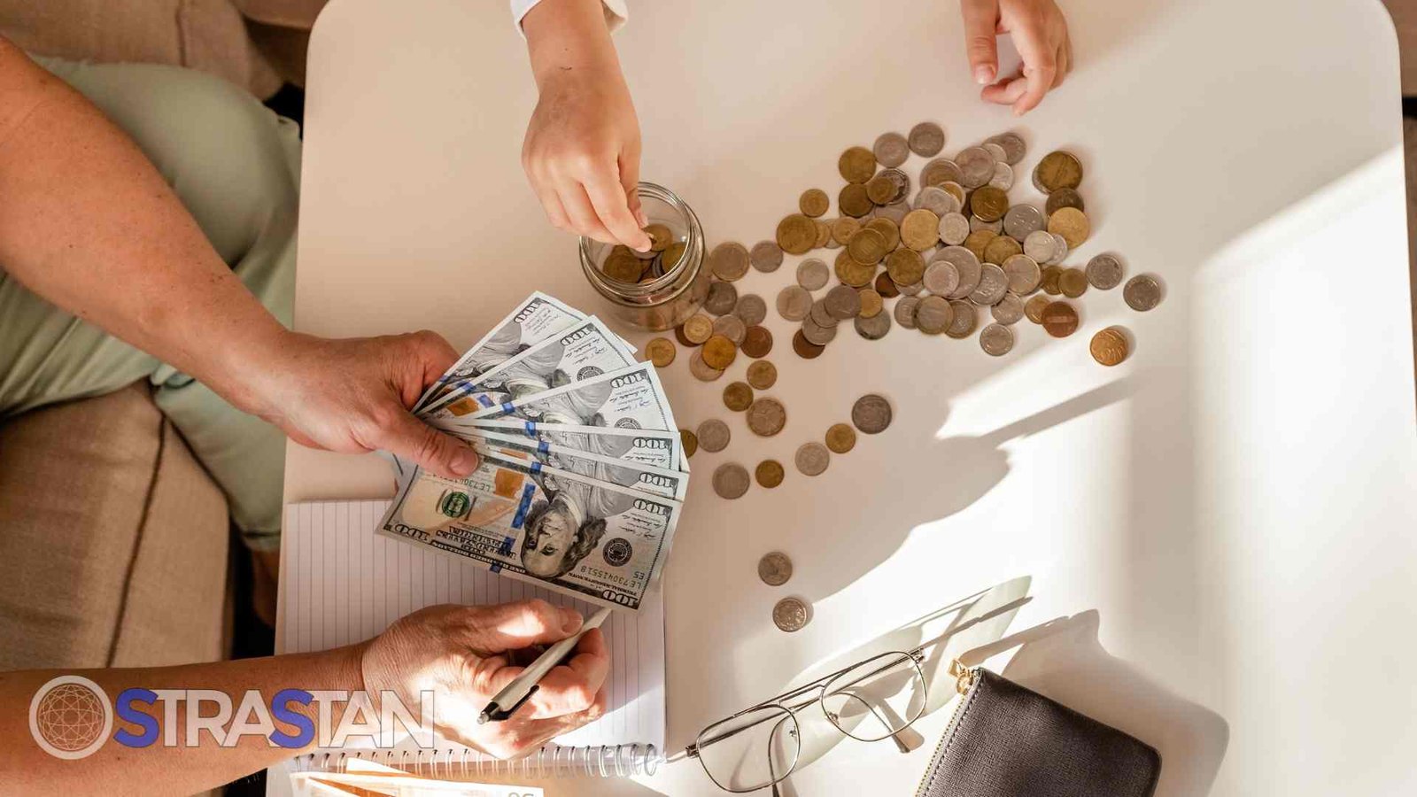Hands sorting money and coins, representing financial management and budget planning.